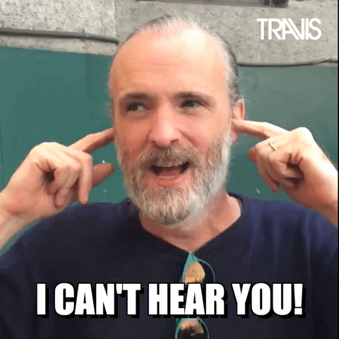 A Man With A Beard Is Covering His Ears With His Hands And Says " I Can T Hear You " GIF