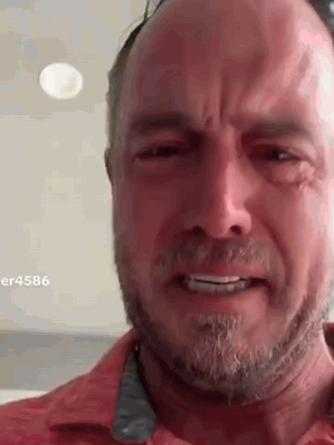 A Man With A Beard Is Crying While Wearing Sunglasses . GIF