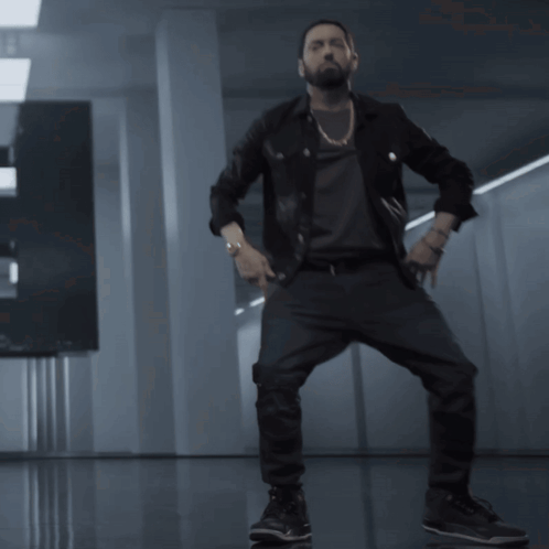 A Man With A Beard Is Dancing In A Room GIF