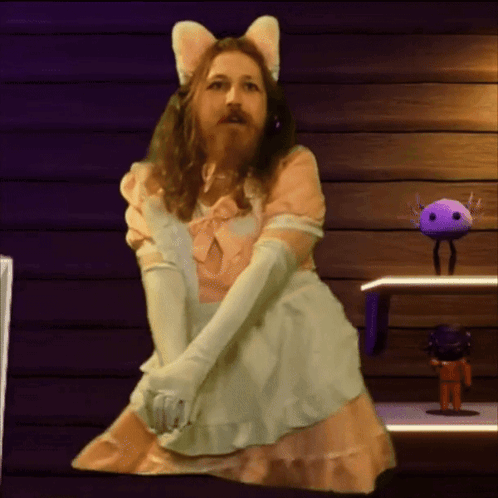 A Man With A Beard Is Dressed In A Maid Costume GIF