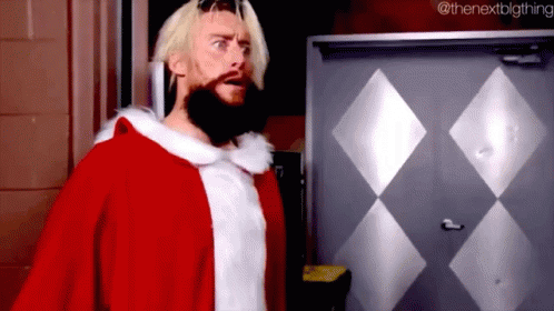 a man with a beard is dressed in a santa claus costume .