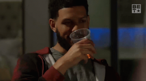 A Man With A Beard Is Drinking From A Plastic Cup And Says Too Easy . GIF
