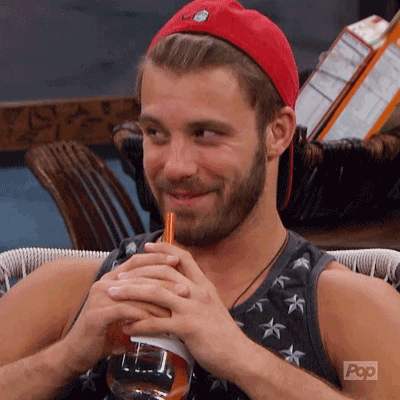 A Man With A Beard Is Drinking Through A Straw From A Bottle . GIF
