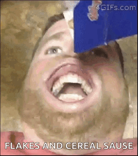 A Man With A Beard Is Eating Flakes And Cereal Sauce . GIF