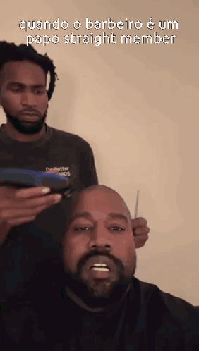A Man With A Beard Is Getting His Hair Cut By Another Man With Dreadlocks GIF