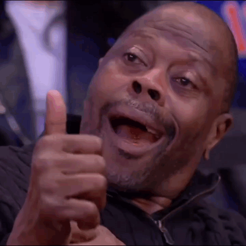 A Man With A Beard Is Giving A Thumbs Up Sign . GIF