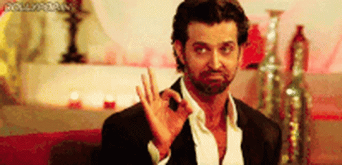A Man With A Beard Is Giving The Ok Sign With His Hand . GIF