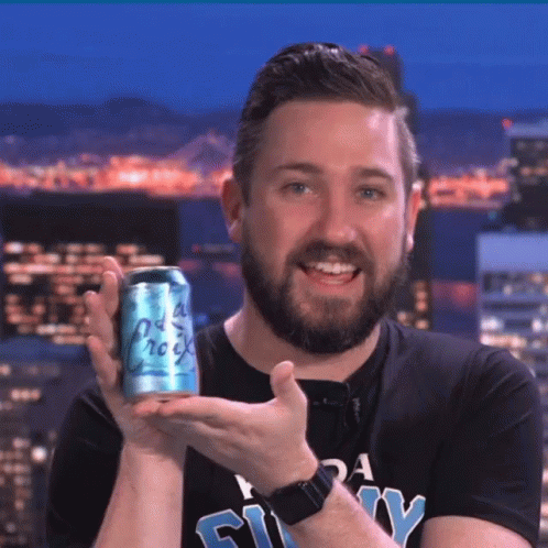 A Man With A Beard Is Holding A Can Of Soda That Says " Old Rock " GIF