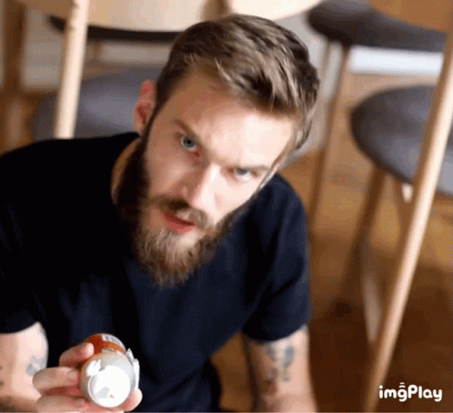 A Man With A Beard Is Holding A Can That Says Imgplay On The Bottom GIF