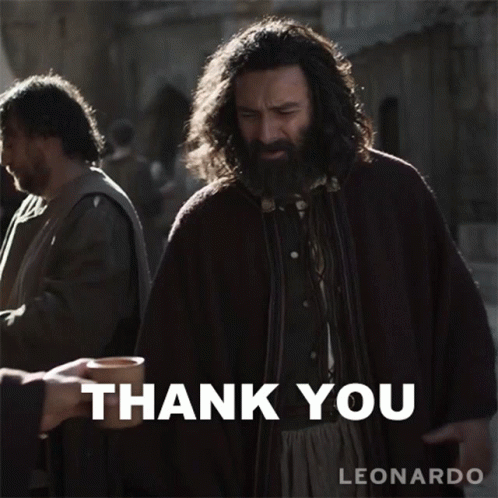 A Man With A Beard Is Holding A Cup In Front Of A Thank You Sign GIF