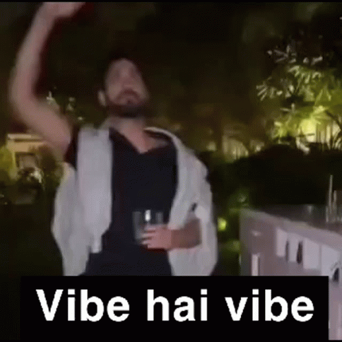 A Man With A Beard Is Holding A Glass Of Beer And Dancing In A Video . GIF