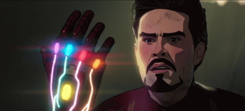 A Man With A Beard Is Holding A Glove With A Bunch Of Stones On It . GIF