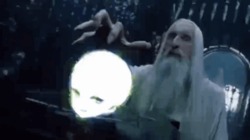 A Man With A Beard Is Holding A Glowing Ball In His Hand . GIF