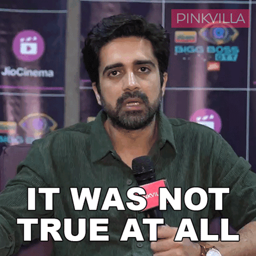 A Man With A Beard Is Holding A Microphone And Saying It Was Not True At All GIF