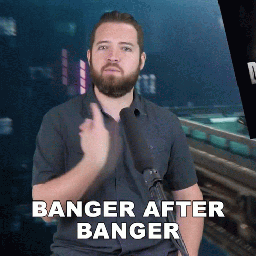 A Man With A Beard Is Holding A Microphone And Says Banger After Banger GIF