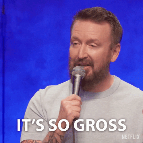 A Man With A Beard Is Holding A Microphone And Says " It 'S So Gross " GIF
