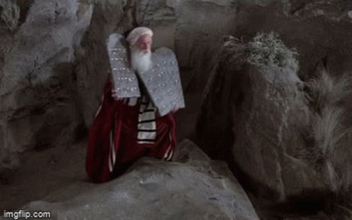 A Man With A Beard Is Holding A Plaque With The Words Has Given Unto You Written On It GIF
