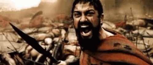 A Man With A Beard Is Holding A Sword In Front Of A Crowd Of Soldiers . GIF