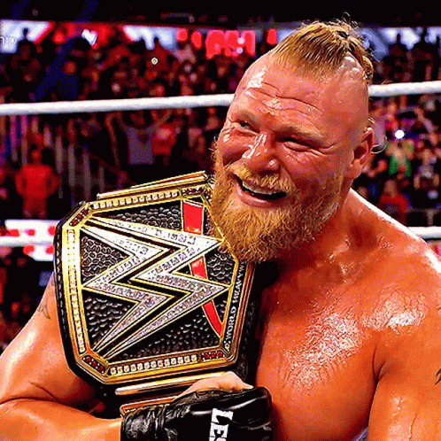 A Man With A Beard Is Holding A Wrestling Belt That Says Wwe GIF