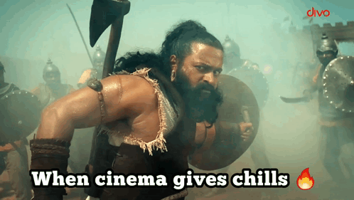 A Man With A Beard Is Holding An Axe And Shield With The Words When Cinema Gives Chills Below Him GIF