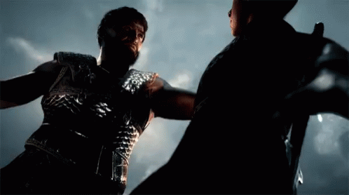 A Man With A Beard Is Holding Another Man 'S Arm GIF