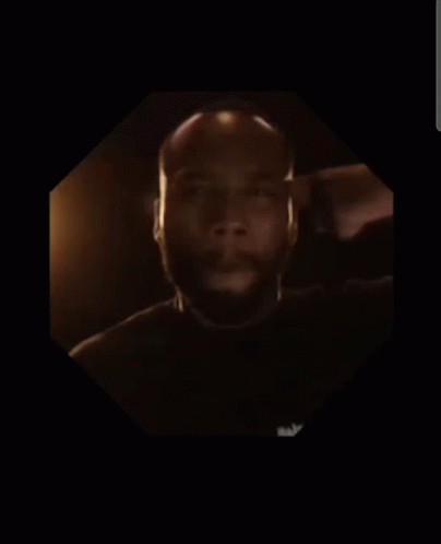A Man With A Beard Is In A Dark Room GIF