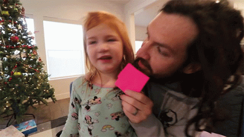 A Man With A Beard Is Kissing A Little Girl Who Is Wearing A Minnie Mouse Outfit GIF