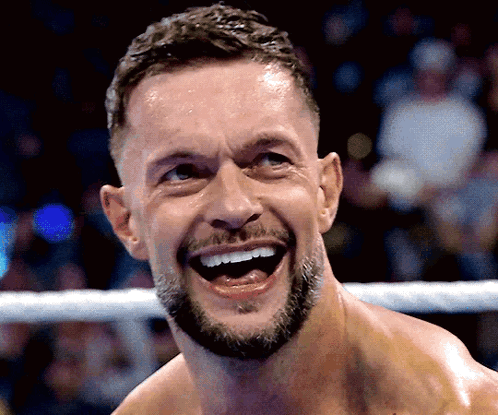 A Man With A Beard Is Laughing In A Boxing Ring GIF
