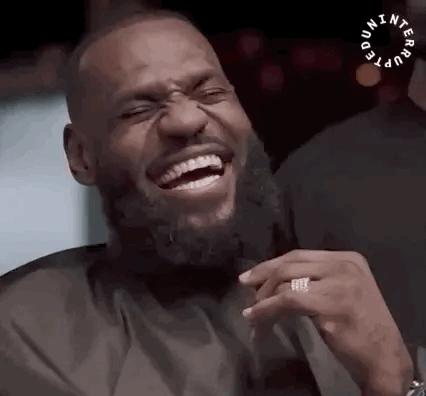 A Man With A Beard Is Laughing With His Eyes Closed And A Ring On His Finger . GIF