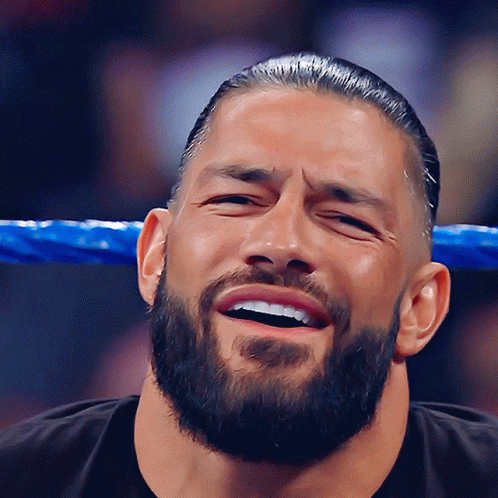 A Man With A Beard Is Laughing With His Eyes Closed GIF