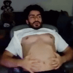 a man with a beard is laying down with his shirt off