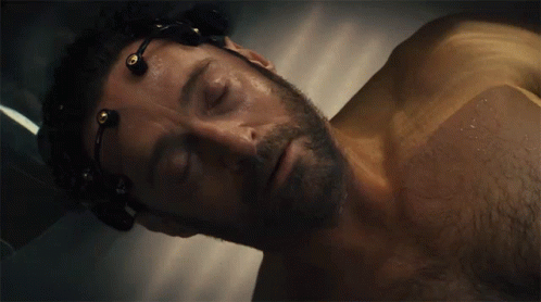 A Man With A Beard Is Laying In A Bathtub With Wires Around His Head GIF