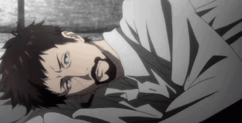 A Man With A Beard Is Laying On A Bed With His Eyes Closed GIF