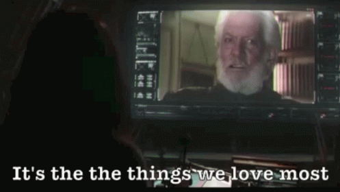 A Man With A Beard Is Looking At A Screen With The Words It 'S The Things We Love Most GIF