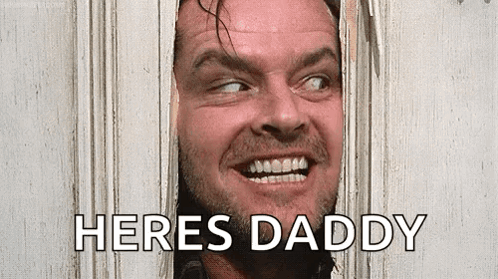 A Man With A Beard Is Looking Through A Hole In A Door And Saying `` Here 'S Daddy '' . GIF