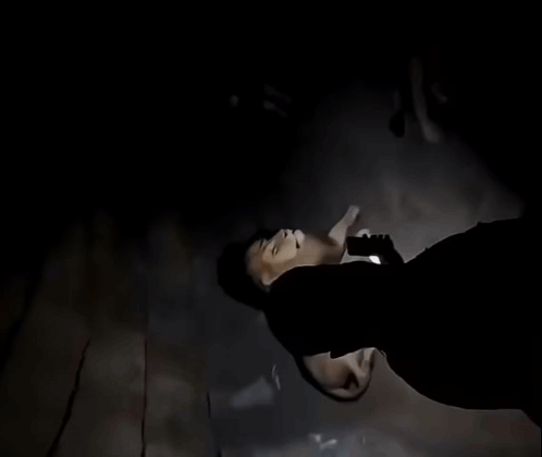 A Man With A Beard Is Looking Up At A Lion In A Cave GIF