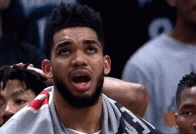 A Man With A Beard Is Looking Up With His Mouth Open . GIF