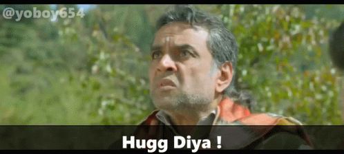 A Man With A Beard Is Looking Up With The Words Hugg Diya Above Him GIF