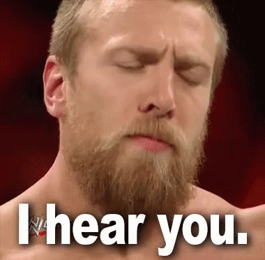 A Man With A Beard Is Making A Face With His Eyes Closed And The Words I Hear You . GIF