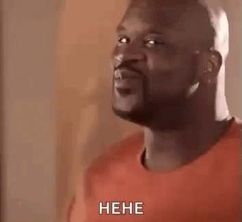 A Man With A Beard Is Making A Funny Face And Laughing While Wearing A Red Shirt . GIF