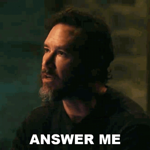 A Man With A Beard Is Making A Funny Face And Says Answer Me . GIF