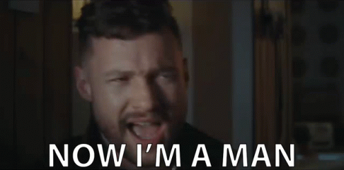 A Man With A Beard Is Making A Funny Face And Says `` Now I 'M A Man '' . GIF