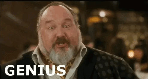 A Man With A Beard Is Making A Funny Face And The Word Genius Is On The Screen . GIF