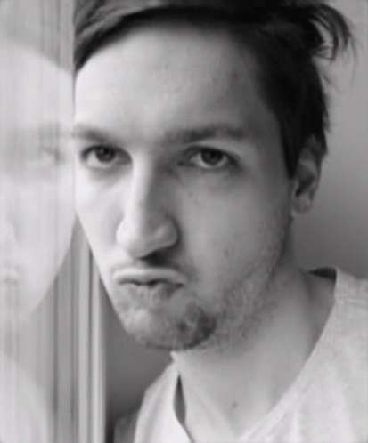 a man with a beard is making a funny face in a black and white photo