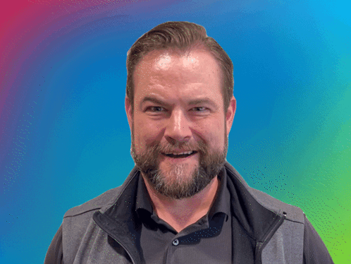 A Man With A Beard Is Making A Funny Face In Front Of A Banner That Says Brilliant GIF