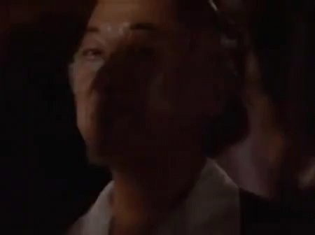 A Man With A Beard Is Making A Funny Face With His Eyes Closed And His Mouth Open . GIF
