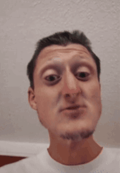 A Man With A Beard Is Making A Funny Face With His Eyes Closed GIF