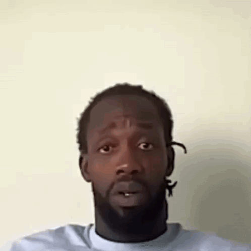 A Man With A Beard Is Making A Funny Face With His Mouth Open . GIF