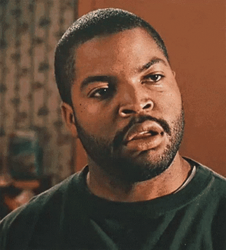A Man With A Beard Is Making A Funny Face With His Mouth Open GIF
