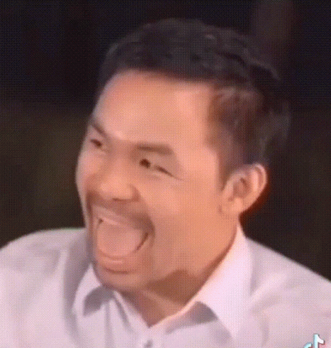 A Man With A Beard Is Making A Funny Face With His Tongue Out . GIF